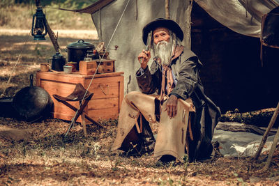 Full length of man sitting on field