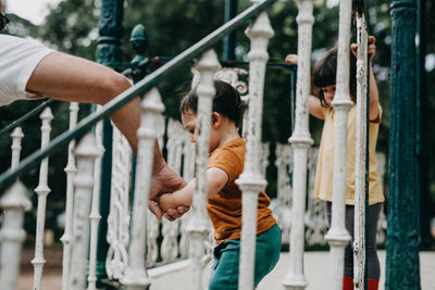 Side view of boy looking at metal