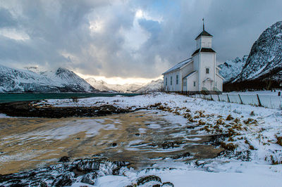 Church by sea against sky