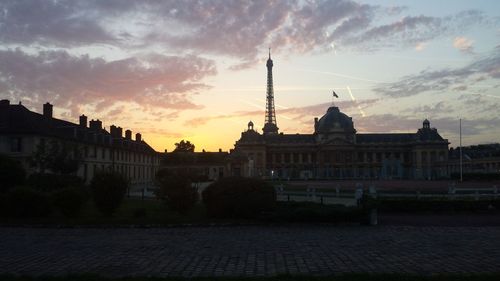 Buildings against cloudy sky at sunset