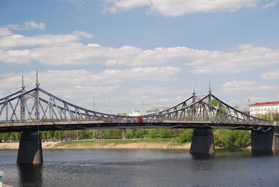 Bridge over river against cloudy sky