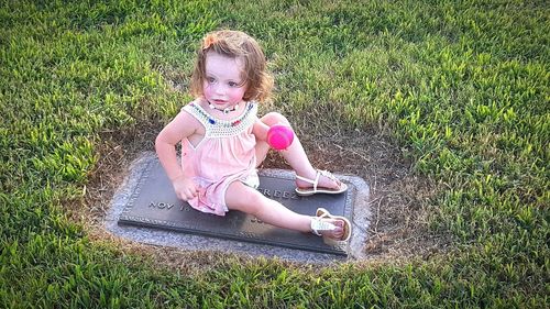 Girl playing on grassy field in park