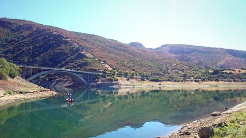 Scenic view of river with mountains in background