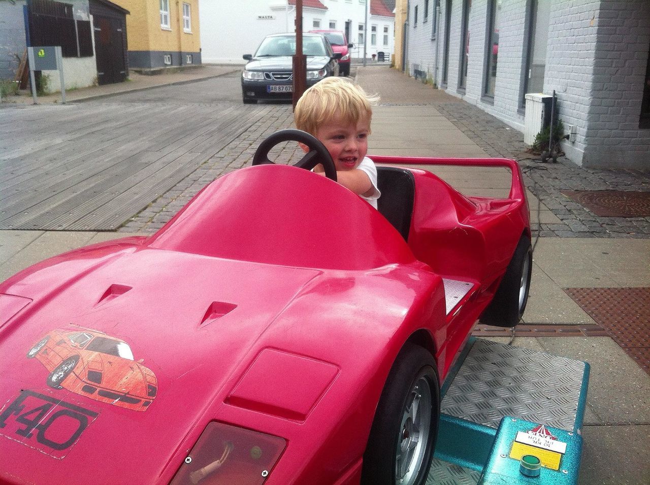 lifestyles, casual clothing, childhood, leisure activity, red, full length, person, street, elementary age, sitting, boys, cute, front view, innocence, car, land vehicle, transportation, day