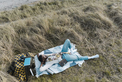 High angle view of woman lying on field