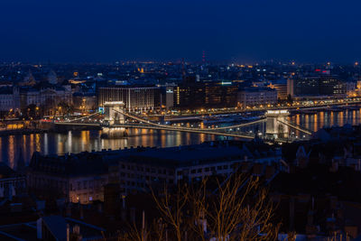 Illuminated cityscape against sky at night