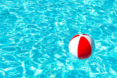 High angle view of red floating on swimming pool