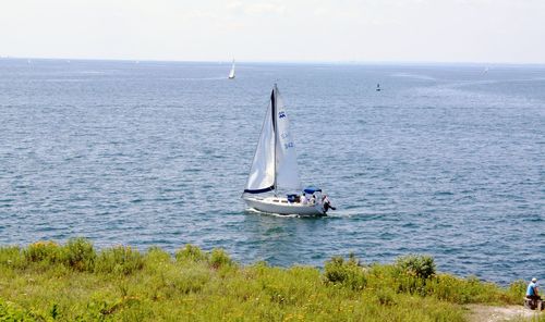 Boat sailing in sea against sky