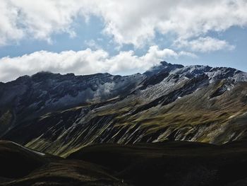 View of mountain range against cloudy sky