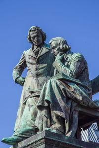 Low angle view of statue against blue sky