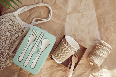 Sustainable tableware cutlery, cardboard cups made from natural materials and reusable bag 