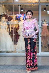 Portrait of smiling woman standing in store