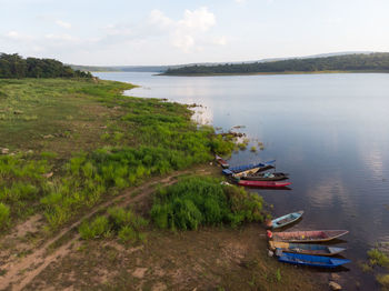 High angle view of boats moored in water against sky