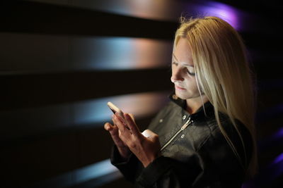 Close-up of young woman using mobile phone