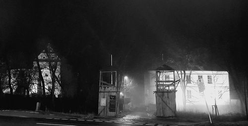 Illuminated clock tower against sky at night