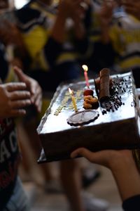 People holding candles on table