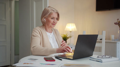 Young woman using laptop at home