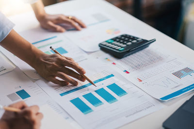 High angle view of people in pen on table