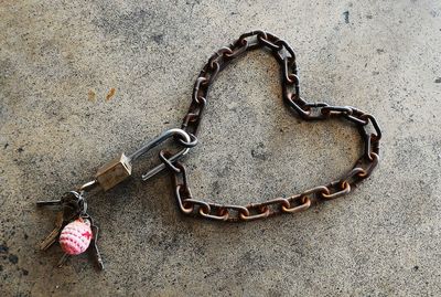 High angle view of heart shape chain on footpath