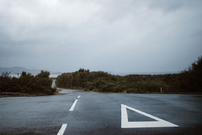 Diving lines on country road against sky