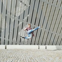 Full length of woman standing by railing