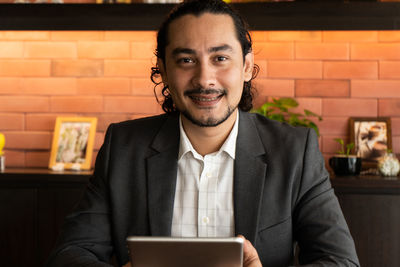 Portrait of young man using mobile phone