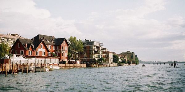 Buildings against cloudy sky