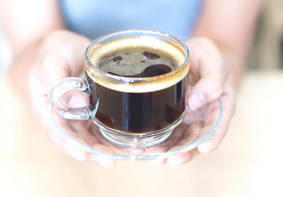 Close-up of hand holding coffee cup