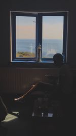 Man sitting by window at home