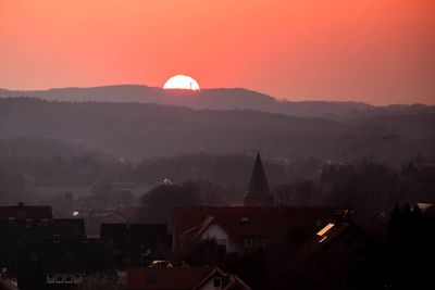 High angle view of buildings against sky during sunset