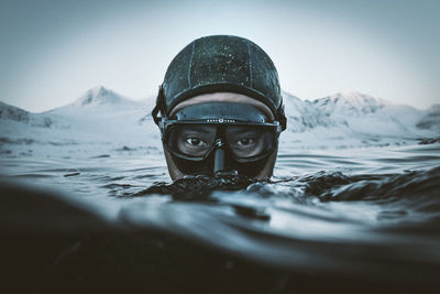 Portrait of man in sea against mountains