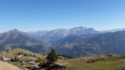 Scenic view of mountains against clear blue sky