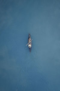 High angle view of person sailing on sea in canoe