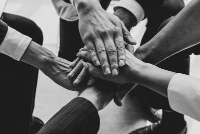 Group of people stacking hands