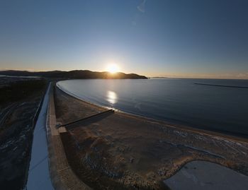 Scenic view of sea against clear sky during sunset