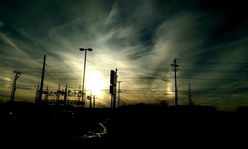 Low angle view of electricity pylon against sky