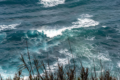 High angle view of waves splashing on shore