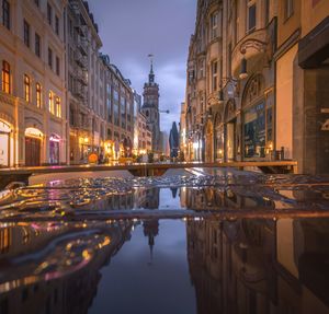 Reflection of buildings in city at night