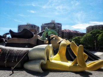 Panoramic view of sculpture in city against sky