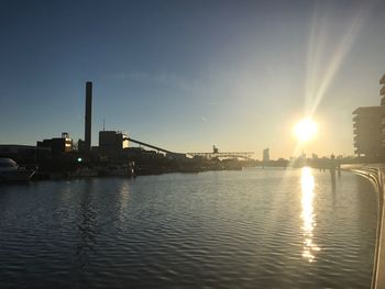 Scenic view of river against sky at sunset