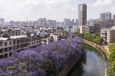 Panoramic shot of buildings by city against sky