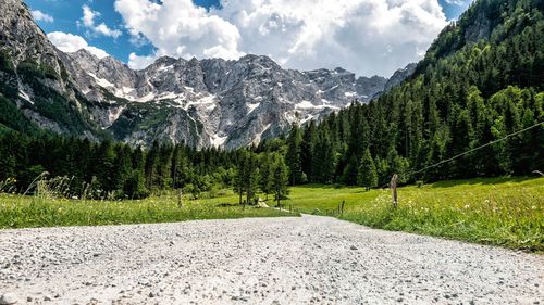 Empty gravel road in idyllic alpine valley. mountains, nature, spring, summer.