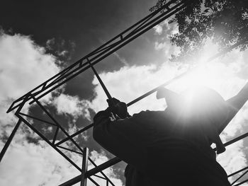 Low angle view of silhouette man against sky