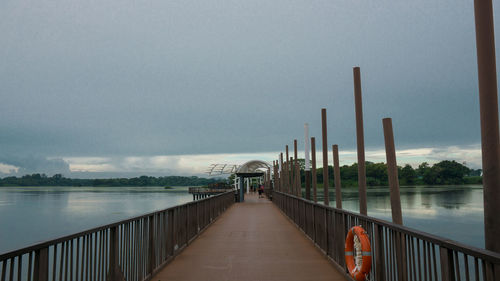 Pier over lake against sky