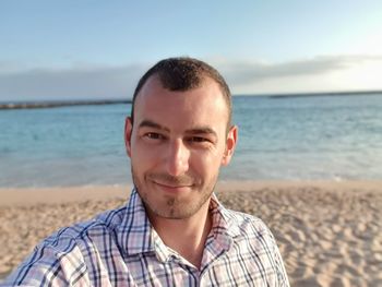 Portrait of smiling young man on beach