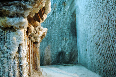 Close-up of rocks by sea against wall