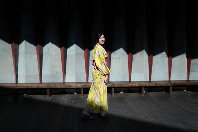 Portrait of woman standing walking on deck