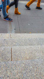 Low section of person standing on road