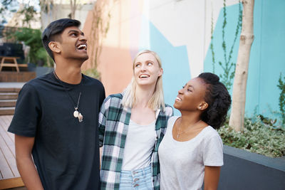 Portrait of smiling friends standing at home