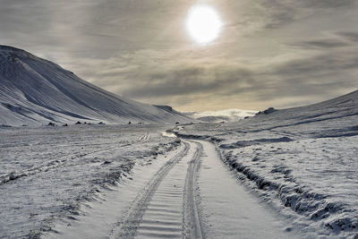 Scenic view of snowcapped mountains against sky during winter